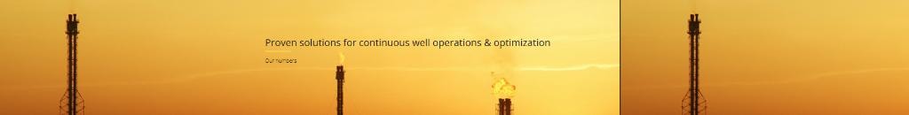 Oil well flare towers at sunset